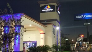 A hotel with a HomeBridge Inn & Suites sign, a BBVA Compass ATM, and a Luby's store.