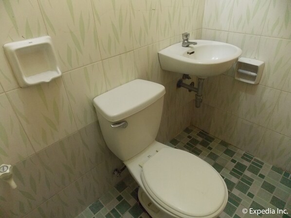 A small bathroom with a toilet, sink, and a hand dryer.