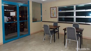 A restaurant with a blue-framed entrance, a McDonald's sign, and a large window with a view. - GV Hotels Talisay City (Talisay)