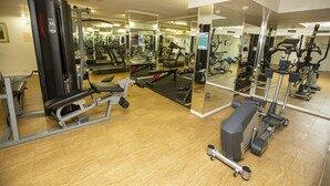 A gym with various exercise equipment, including treadmills, weight machines, and free weights. - Springwood Tower Apartment Hotel (Springwood)