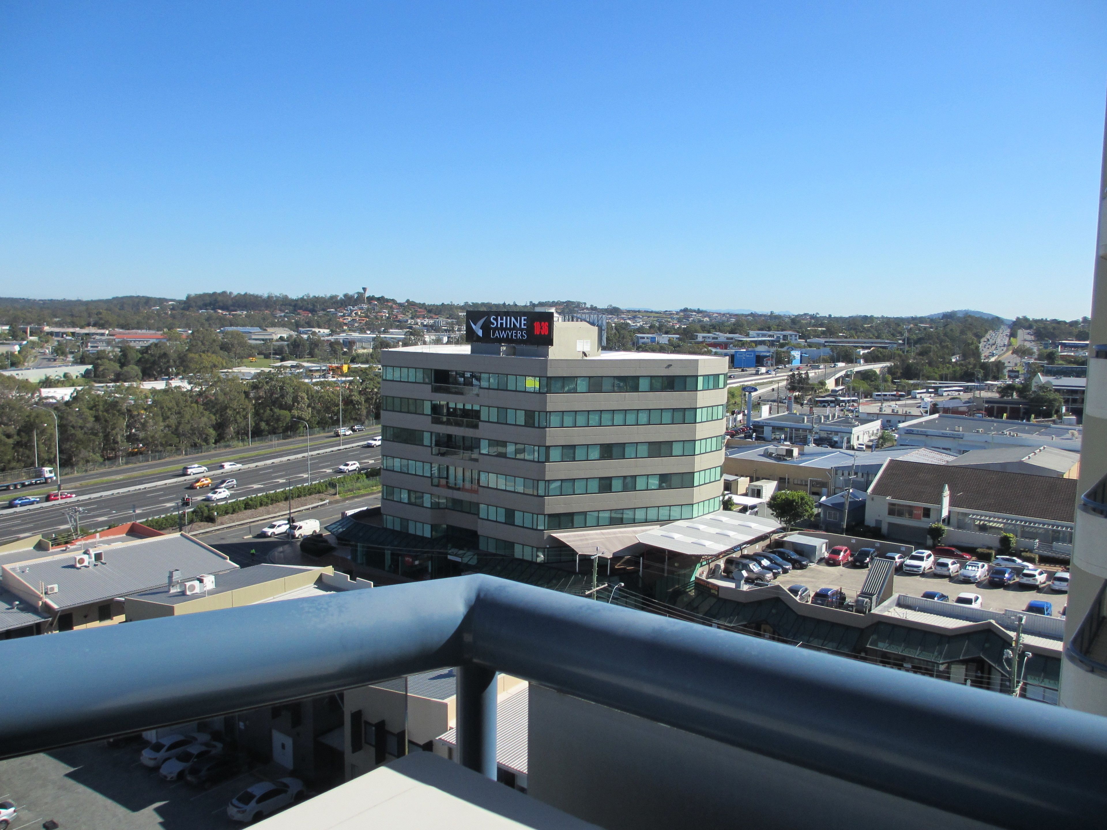 A multi-story building with a sign for "Shine Lawyers" on the top.