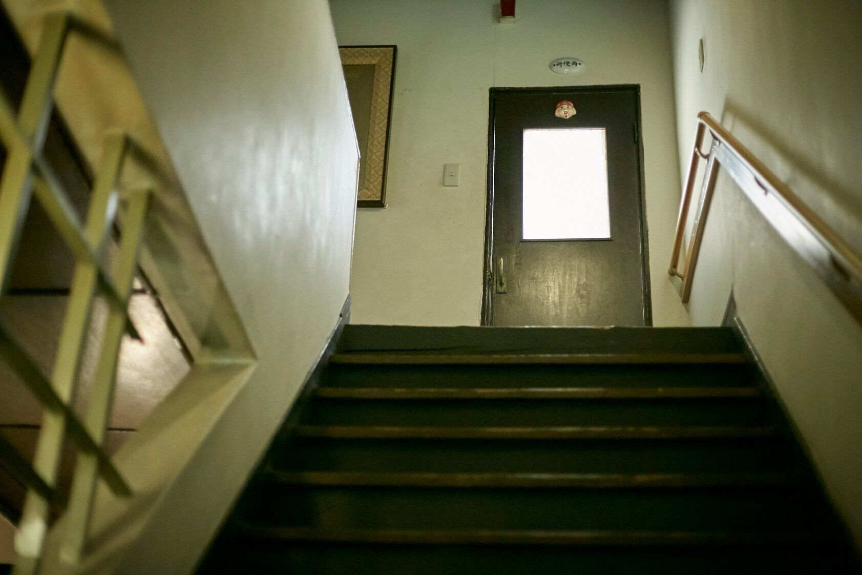 A staircase leading to a door with a small window above it.