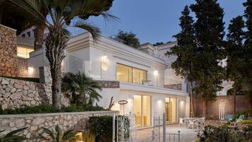Relax in a serene garden setting with a patio area perfect for dining or unwinding.