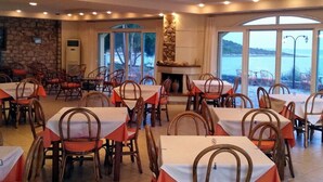A restaurant with tables and chairs arranged for dining. - Annema Hotel (Monemvasia)