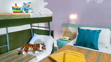 Cozy room with a bunk bed and single bed, featuring a nightstand with a telephone and lamp.