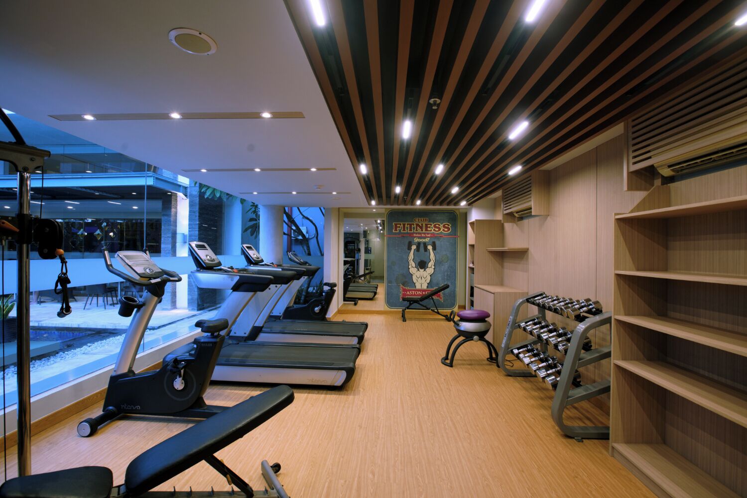 A gym with treadmills, a stationary bike, and a weight bench.
