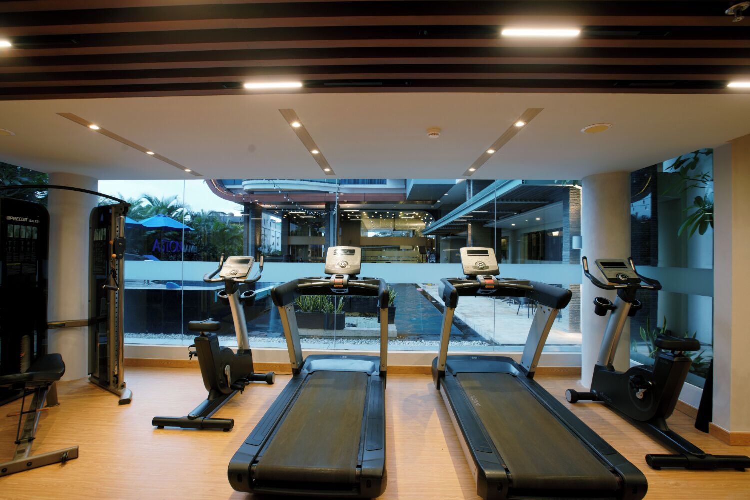 A gym with treadmills, a stationary bike, and a weight machine.