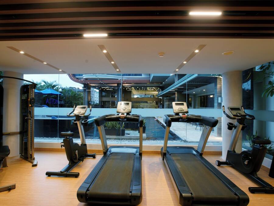 A gym with treadmills, a stationary bike, and a weight machine.