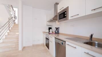 Fridge, microwave, coffee/tea maker, cookware/dishes/utensils