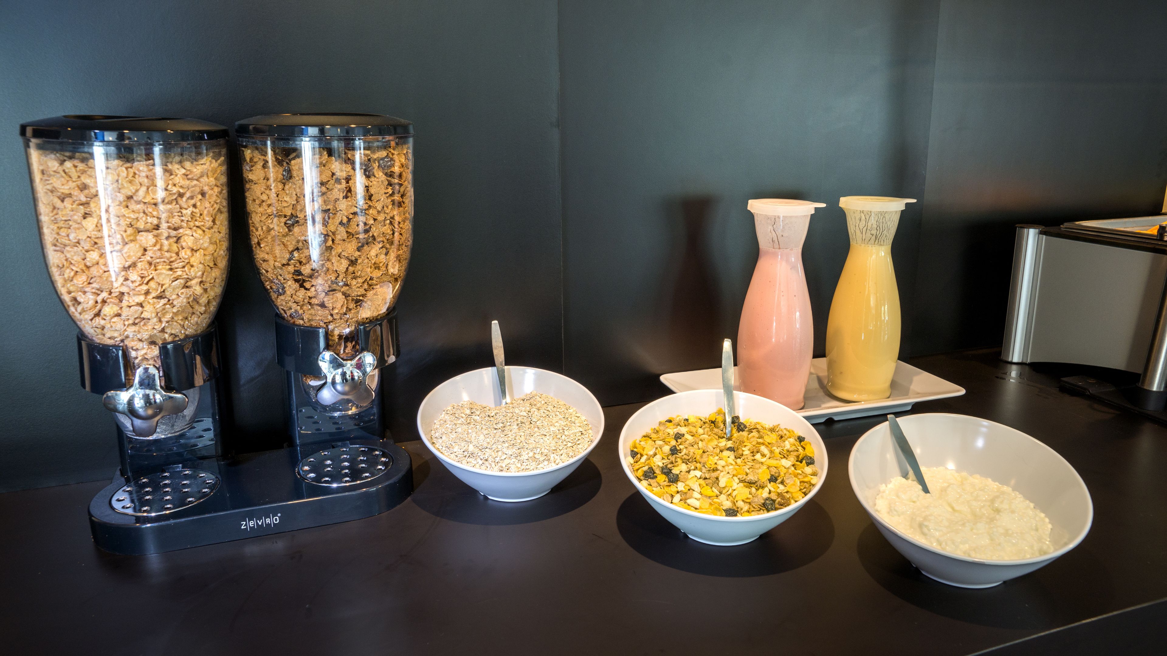 A breakfast buffet with various food options and a coffee machine.