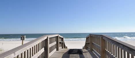 On the beach, white sand, sun loungers, beach umbrellas