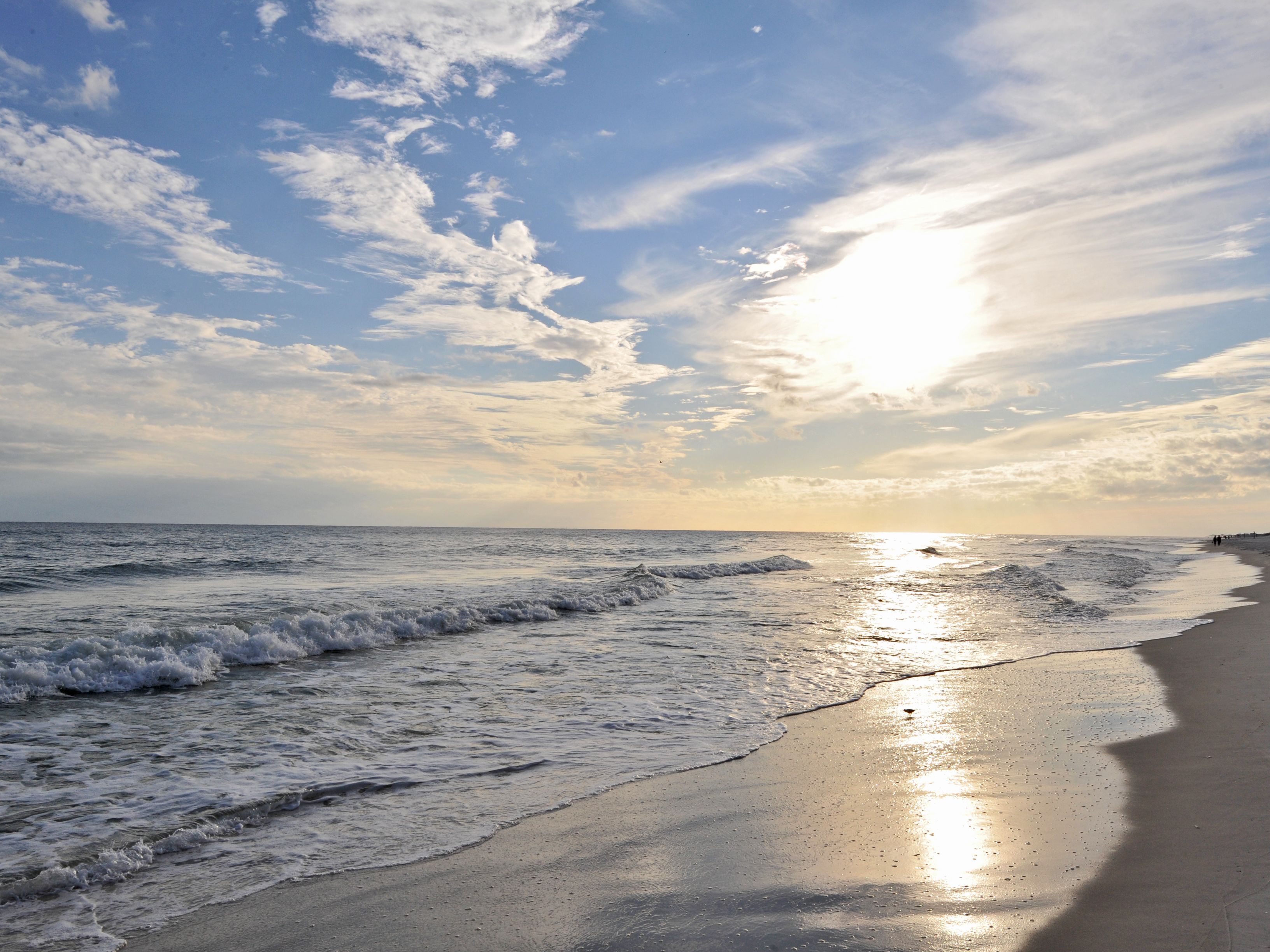 On the beach, white sand, sun loungers, beach umbrellas