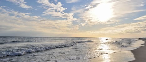 On the beach, white sand, sun loungers, beach umbrellas