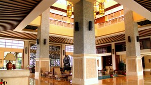 Un hall d’entrée spacieux, doté de hauts plafonds, de grandes colonnes et d’un décor traditionnel.