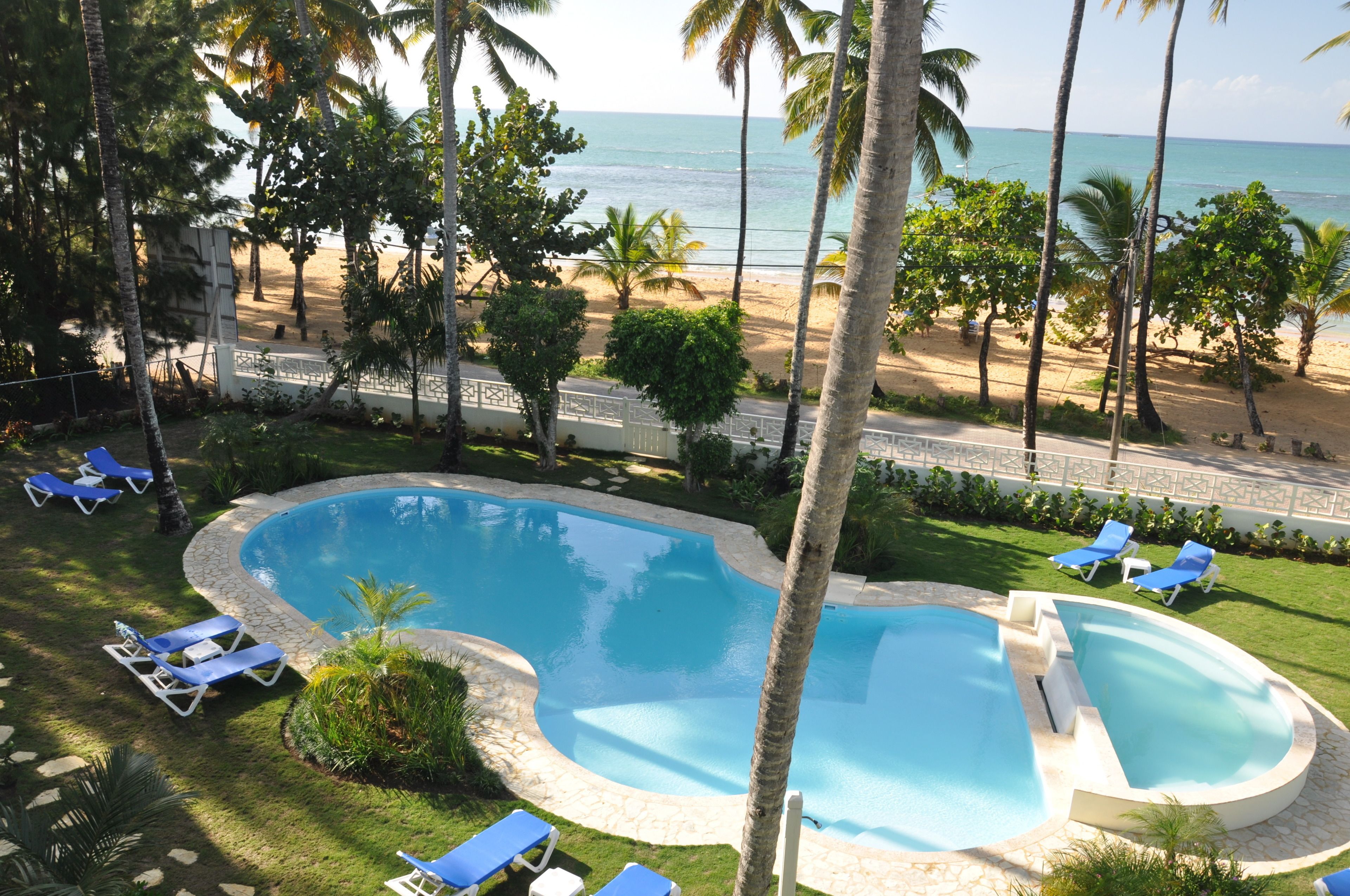 Una piscina al aire libre, sillones reclinables de piscina