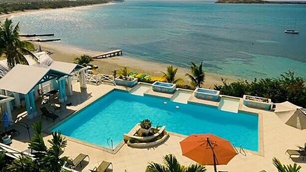 A pool area with a view of the beach and ocean. - Bungalows on the Bay (Christiansted)