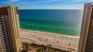 A beach view from a high-rise building with a clear sky. - Shores of Panama Beach Resort (Panama City Beach)
