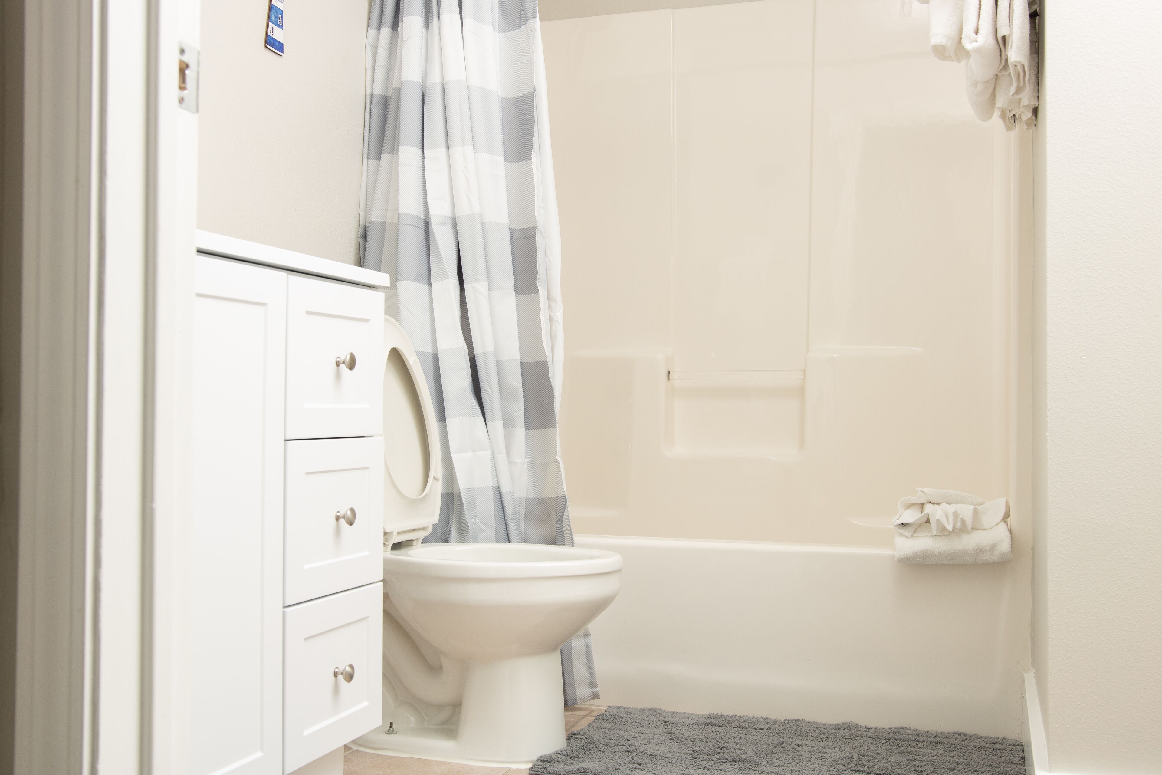 A bathroom with a toilet, a sink, and a bathtub.