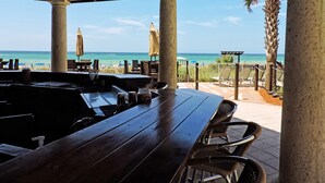 A covered outdoor seating area with a view of the beach and ocean. - Shores of Panama Beach Resort (Panama City Beach)