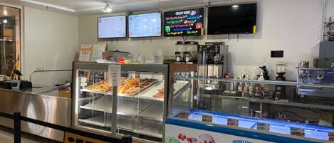 A bakery display with various baked goods and a Hershey's ice cream sign.