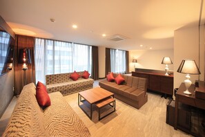 A modern living room with a sofa, two armchairs, a coffee table, and a side table with lamps. - Centurion Hotel Ueno (Tokyo)
