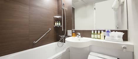 A modern bathroom with a bathtub, a sink, and a shower. There are toiletries on the sink and a towel rack above the mirror.
