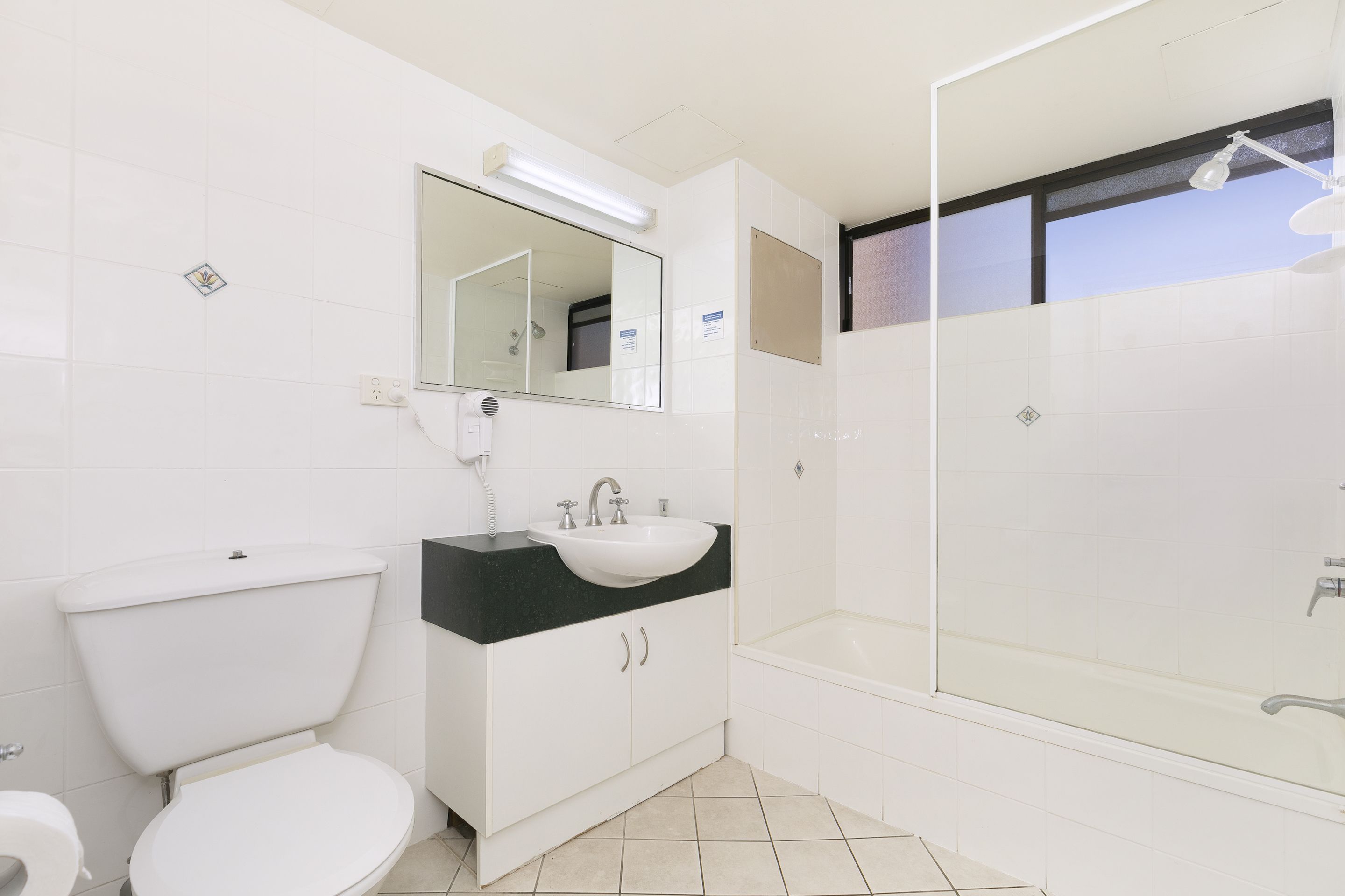 A bathroom with a toilet, sink, and bathtub.