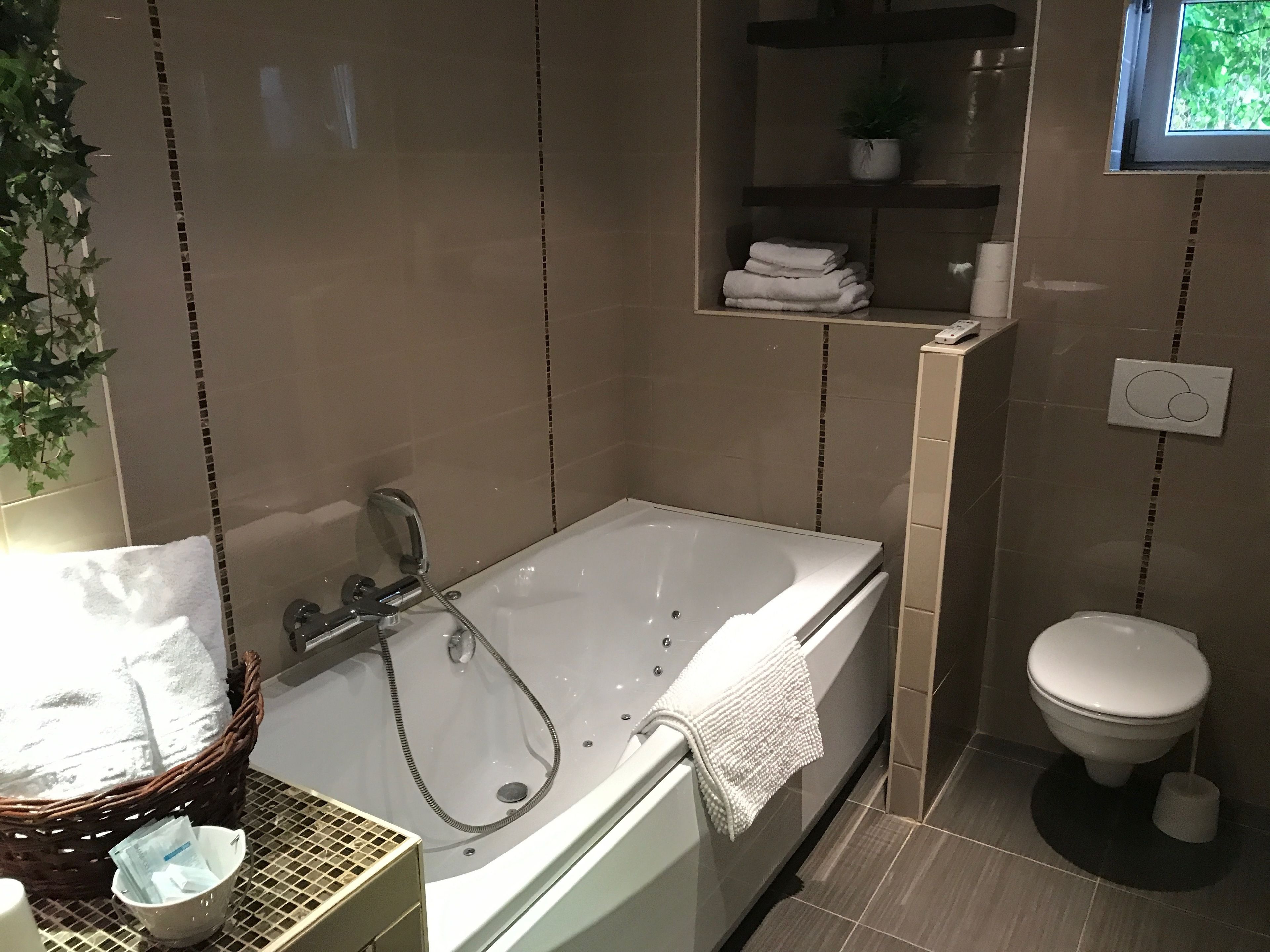 family room, jetted tub | bathroom | deep-soaking bathtub, free toiletries, hair dryer, towels