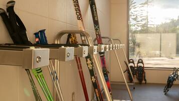 A ski storage rack with skis and ski boots.