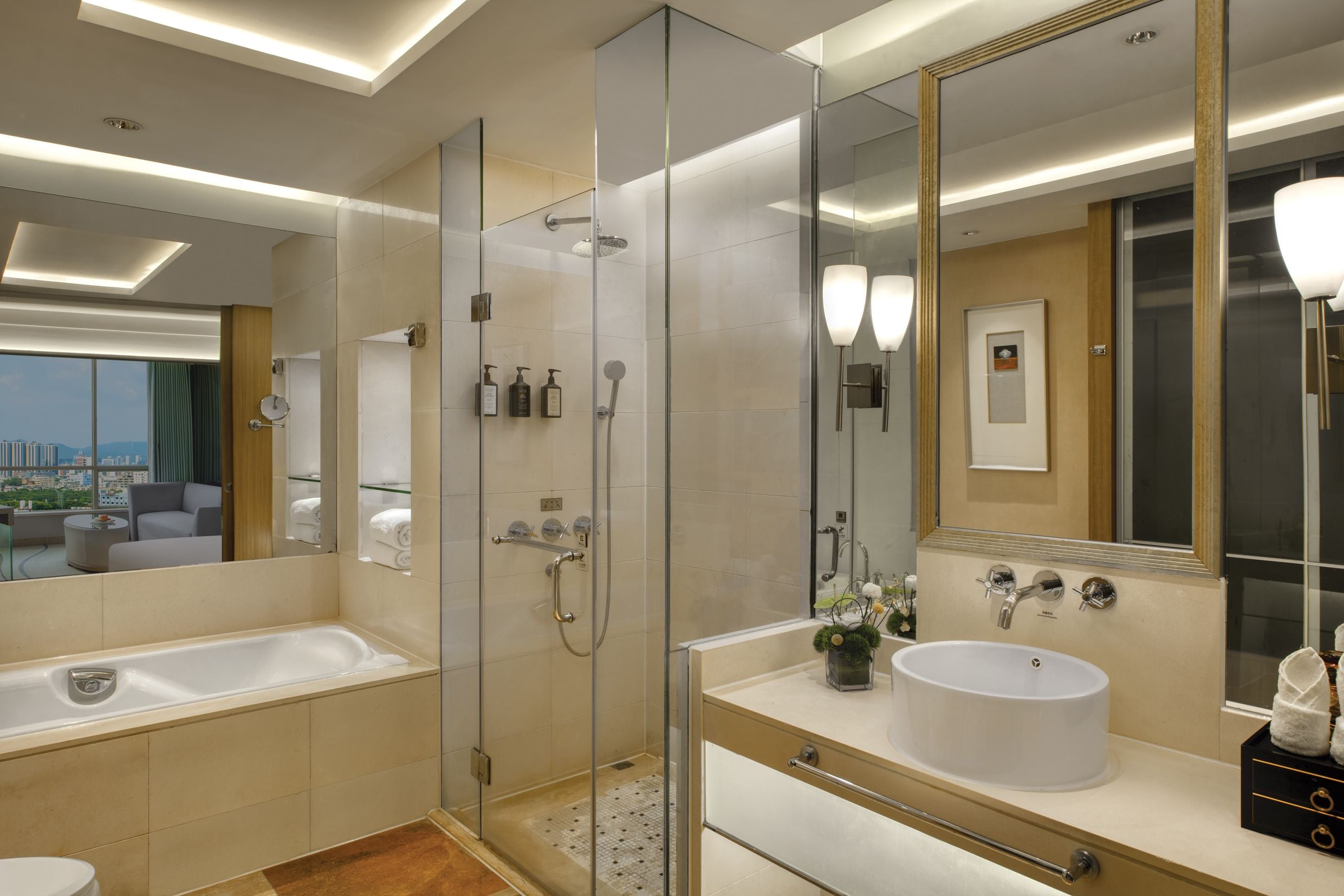 A modern bathroom with a glass-enclosed shower, a bathtub, and a vanity with a large mirror.