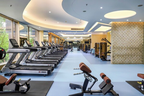 A gym with treadmills, weight machines, and exercise equipment.