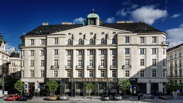 Un edificio grande e histórico, con una entrada central que indica 