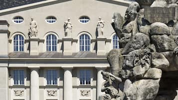 Stately building with classical architectural elements and ornate fountain sculpture.
