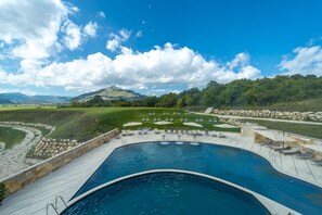 Indoor pool, seasonal outdoor pool, pool umbrellas, pool loungers