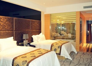 A hotel room with two beds, a large mirror, a glass shower enclosure, and a patterned carpet. - Days Hotel & Suites by Wyndham Hengan Chongqing (Chongqing)