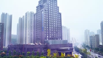 A high-rise building with a modern architectural design, surrounded by other tall buildings and a dense urban environment.