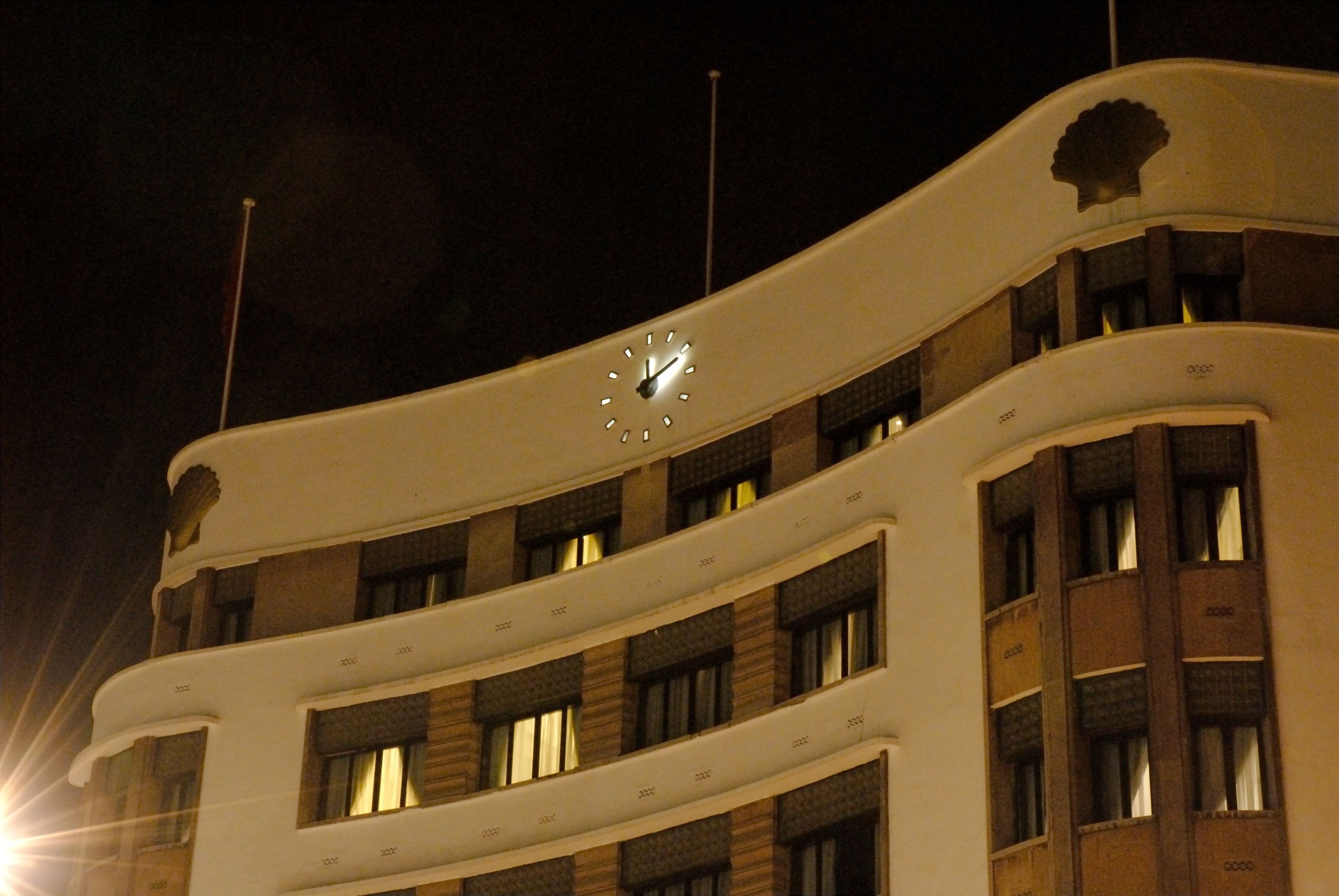 A multi-story building with a prominent clock on the facade.