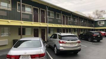 A multi-story hotel with a parking lot.