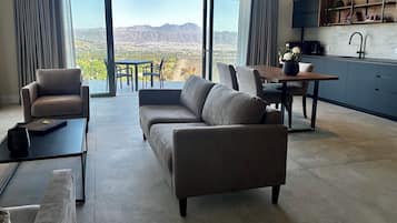 Deluxe Apartment | Living area | 43-inch Smart TV with cable channels, books, heated floors