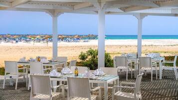 On the beach, white sand, sun-loungers, beach umbrellas