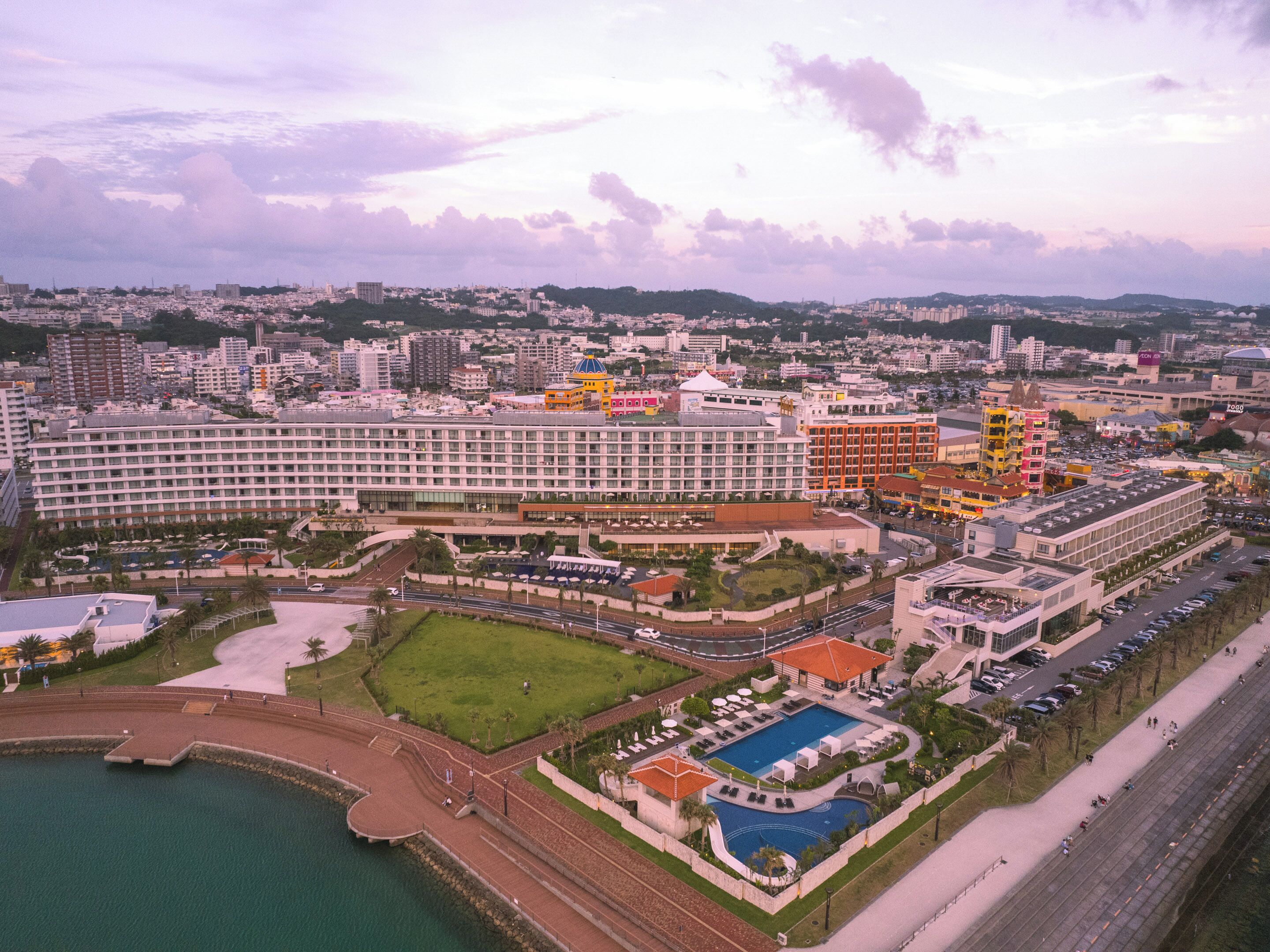 A large hotel complex with multiple buildings, a swimming pool, and a marina.