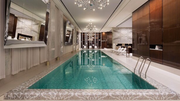 A modern indoor swimming pool with a clear water surface, surrounded by a tiled walkway. - JW Marriott Dongdaemun Square Seoul (Seoul)