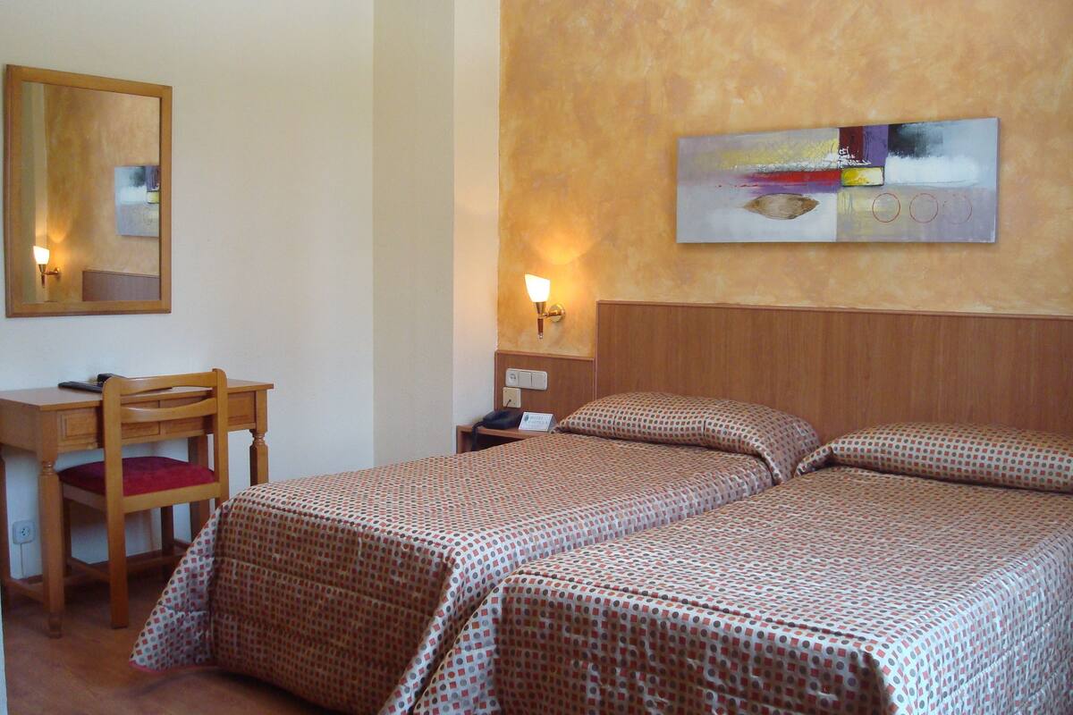 Premium bedding, desk, laptop workspace, blackout drapes