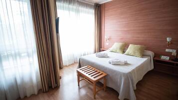 Premium bedding, desk, laptop workspace, blackout curtains