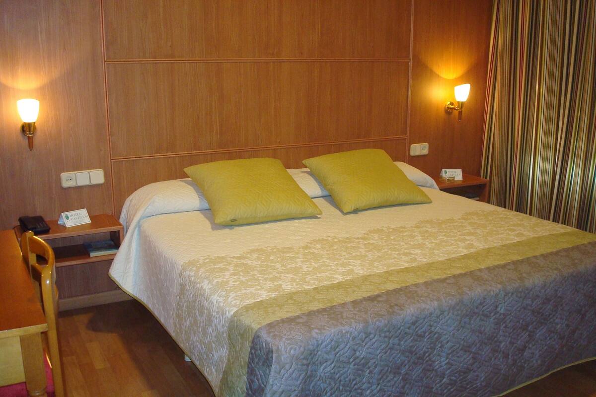 Premium bedding, desk, laptop workspace, blackout drapes