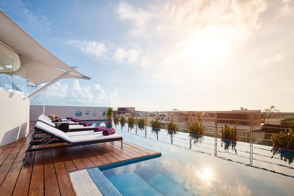 Piscine extérieure, parasols de plage, chaises longues