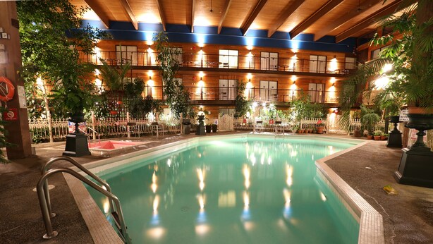 An indoor swimming pool with a wooden ceiling and multiple balconies. - Prestige Vernon Lodge and Conference Centre (Vernon)
