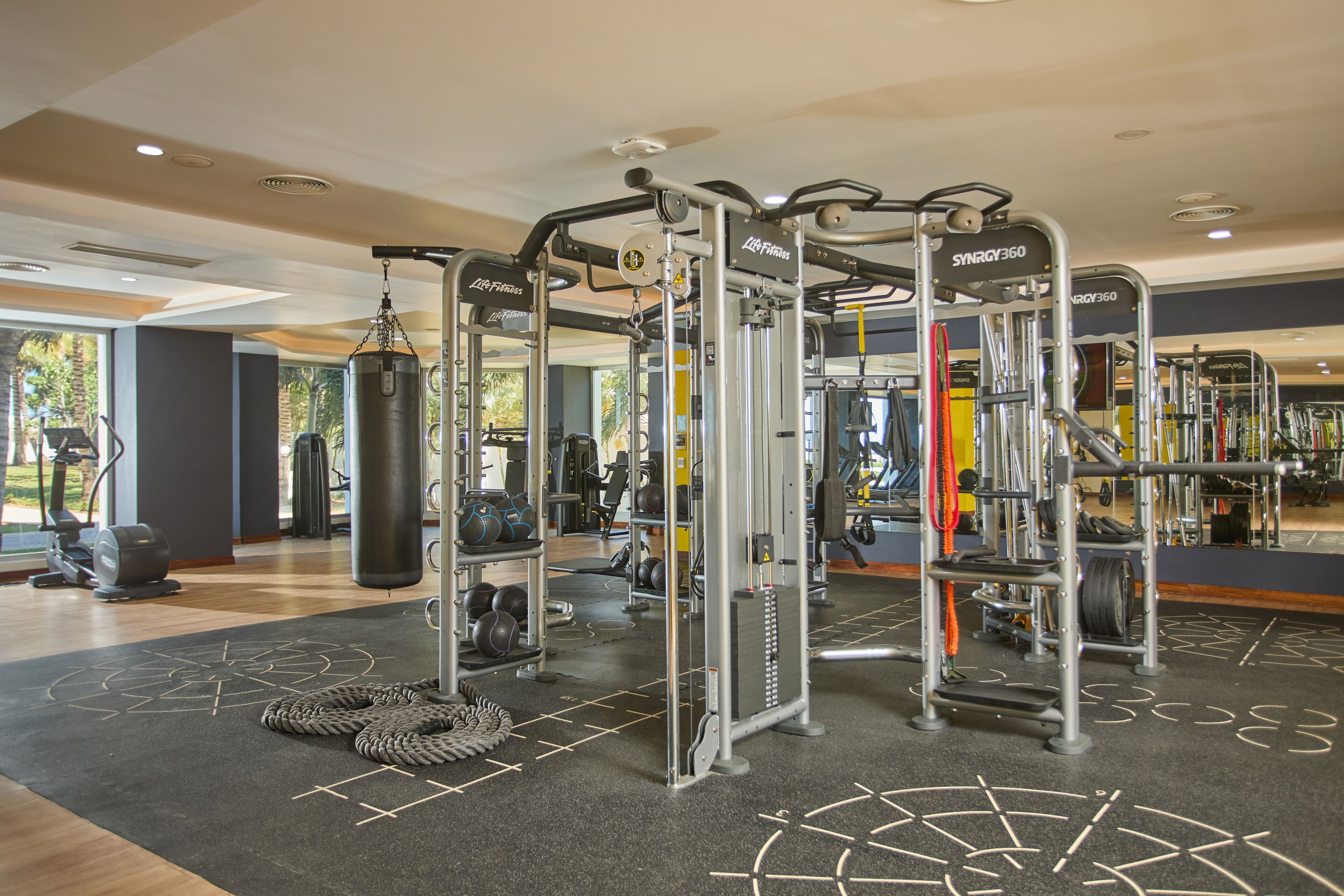 A gym with various exercise equipment, including weight machines and cardio machines.