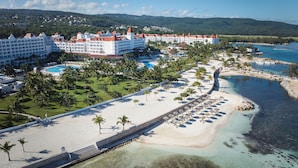 A resort with multiple white buildings, a beach, and a pool area. - Bahia Principe Escape Runaway Bay - Hyatt Inclusive Collection - Adults Only - All Inclusive (Runaway Bay)