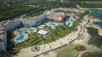 Relax by the interconnected pools and enjoy the ocean views from this resort's beach area surrounded by lush greenery.